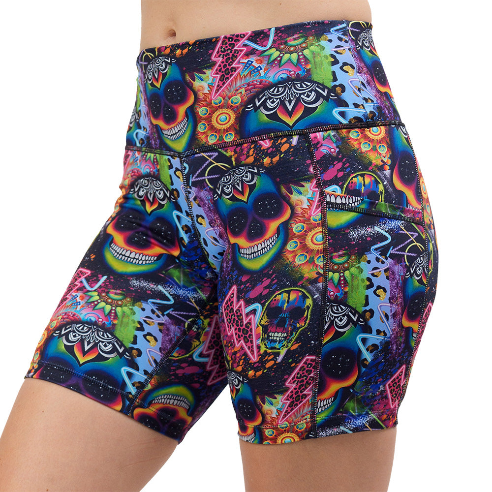 the brightly colored psychedelic skulls pattern against a busy background full of designs 7 inch shorts facing the front against a white background