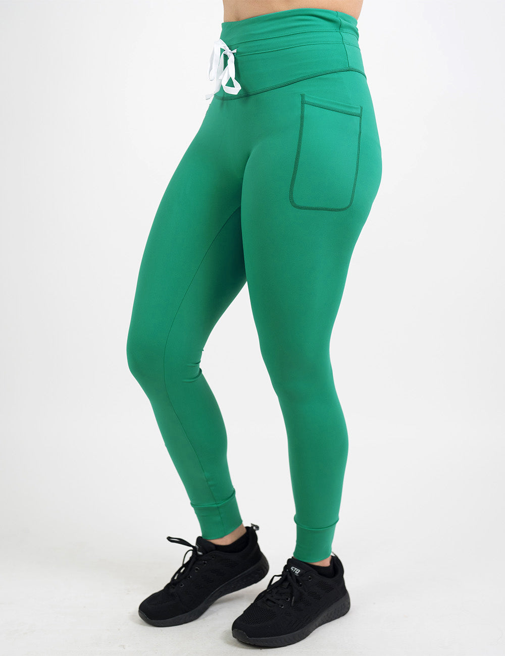 front of the green omni style leggings with a white drawstring against a white background