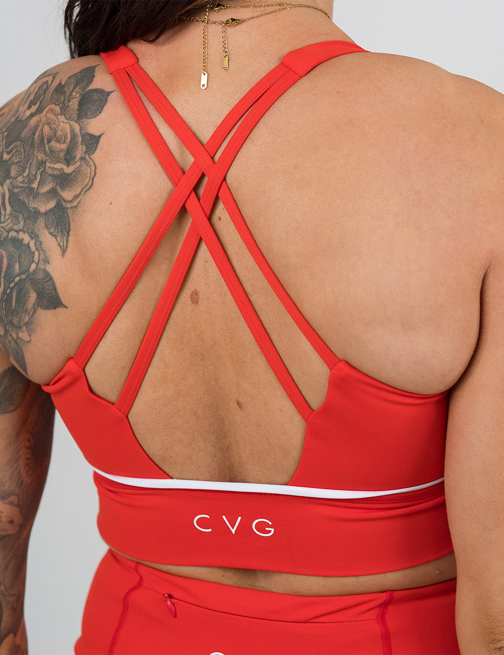 back of the red with white accents longline bra against a white background