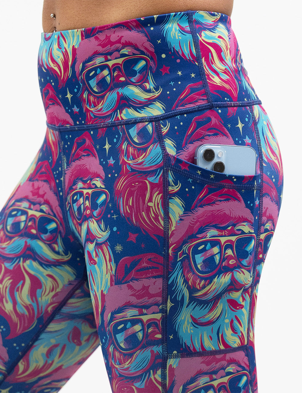 close up of the colorful Santa-in-sunglasses leggings with a phone in its pocket