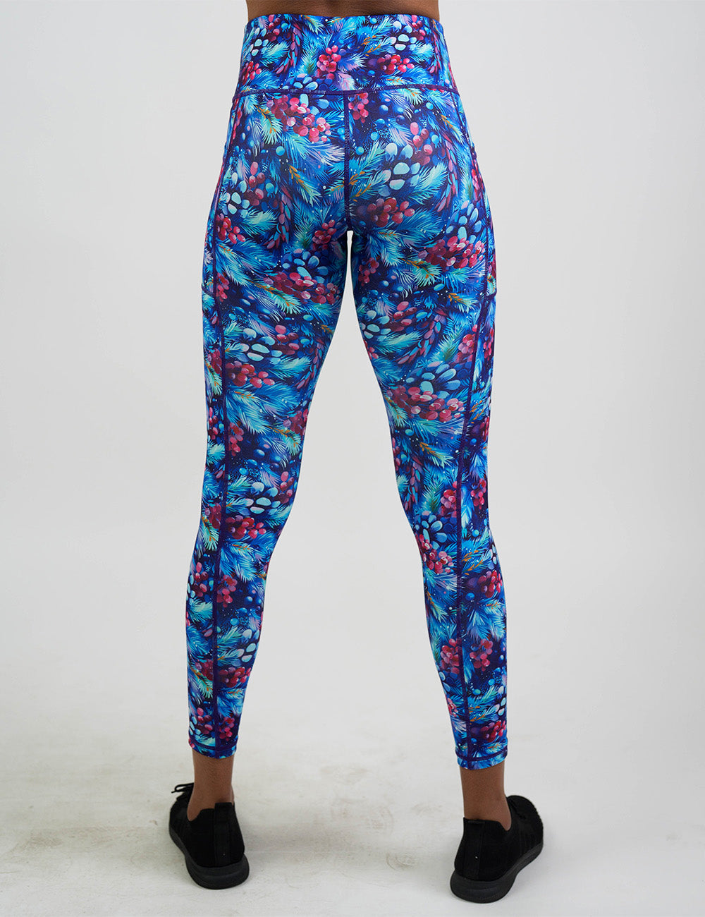 back of the winter berries among blue leaves full length leggings against a white background