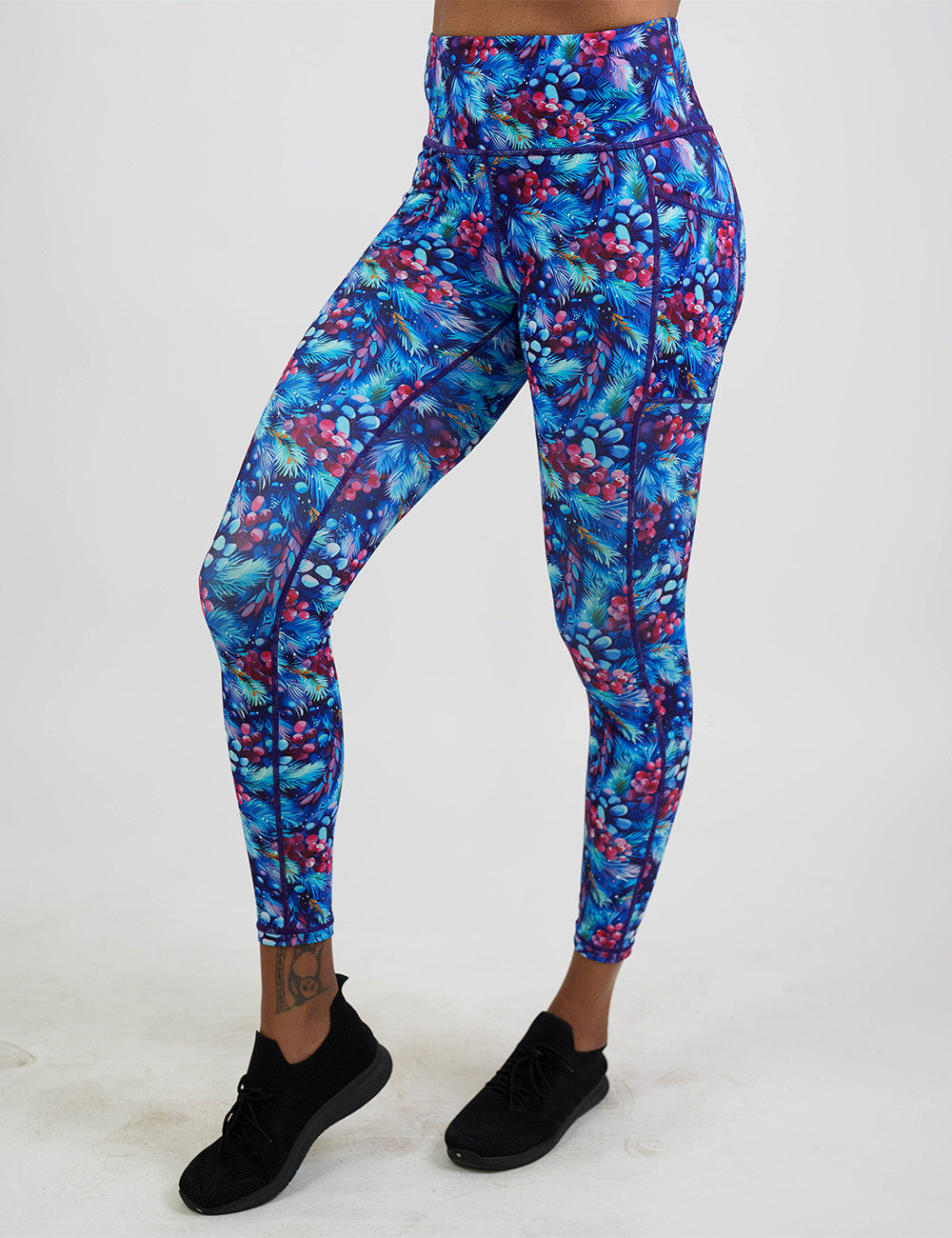 front of the winter berries among blue leaves full length leggings against a white background