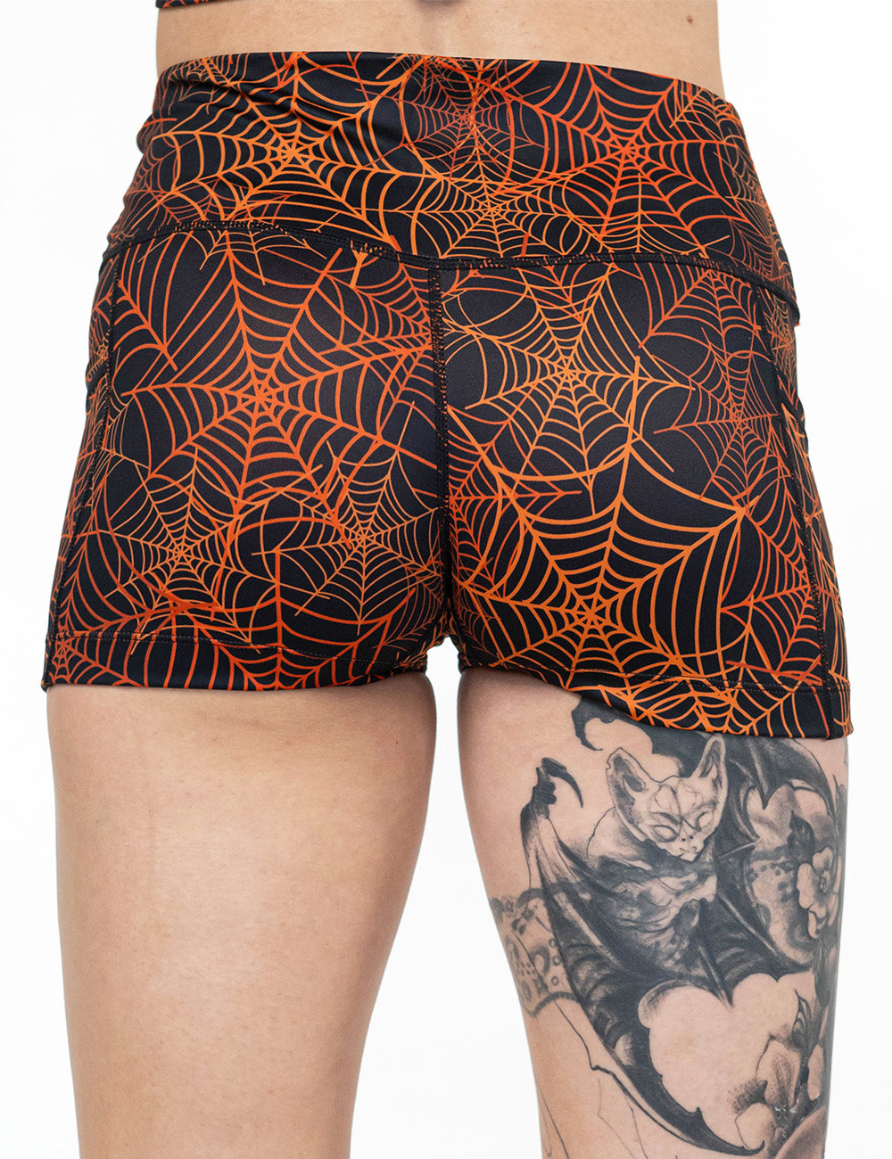 back of the 2.5 inch orange spider webs against a black background shorts against a white background