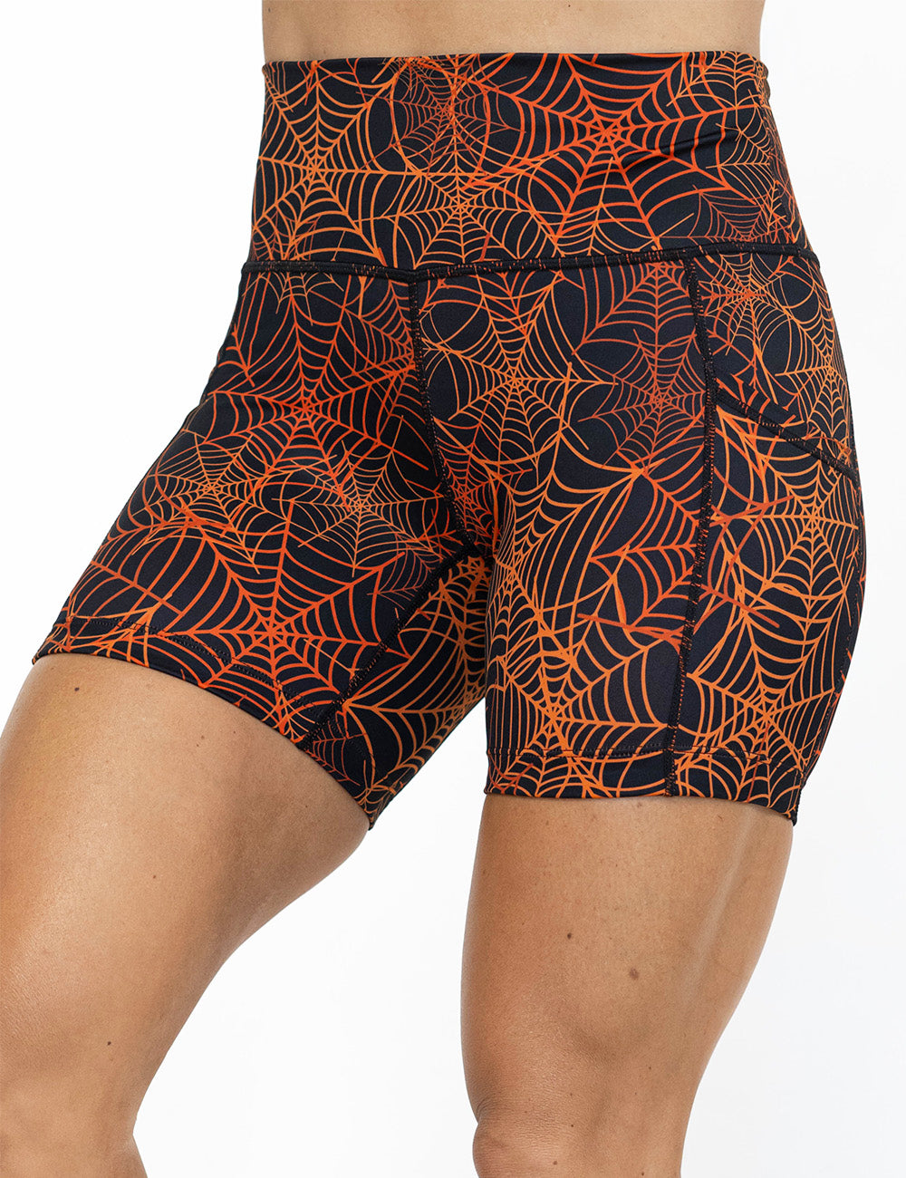 front of the 5 inch orange spider webs against a black background shorts against a white background
