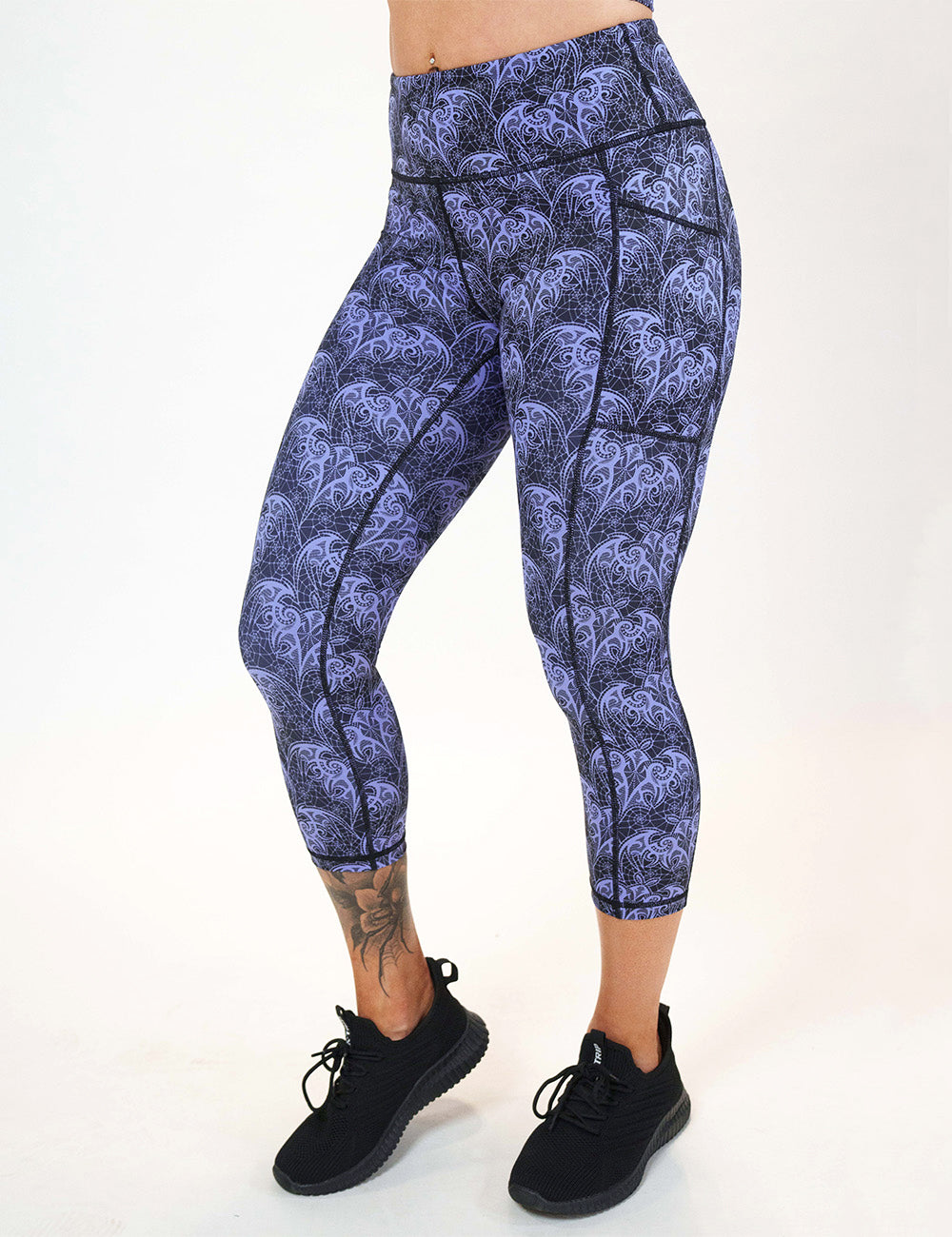 front of the purple lace bats capri leggings against a white background