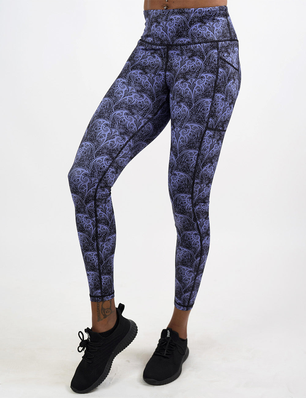 front of the purple lace bats full length leggings against a white background