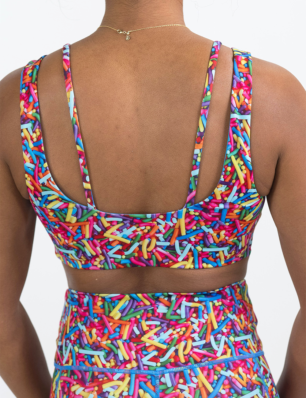 back of the rainbow sprinkles vista bra against a white background