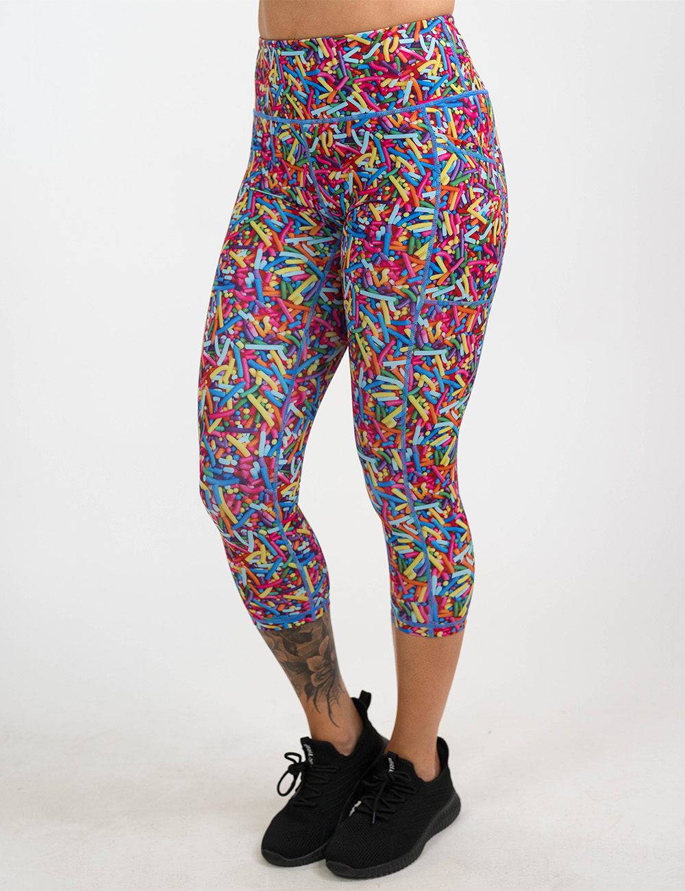 model wearing the rainbow sprinkles capri leggings facing the front against a white background