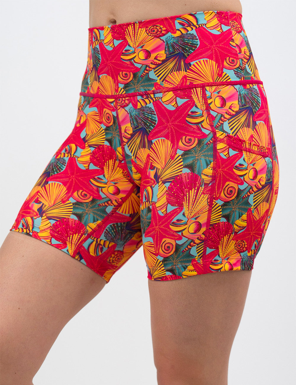front of the 5 inch front of the red starfish with a yellow and blue shell background shorts against a white background