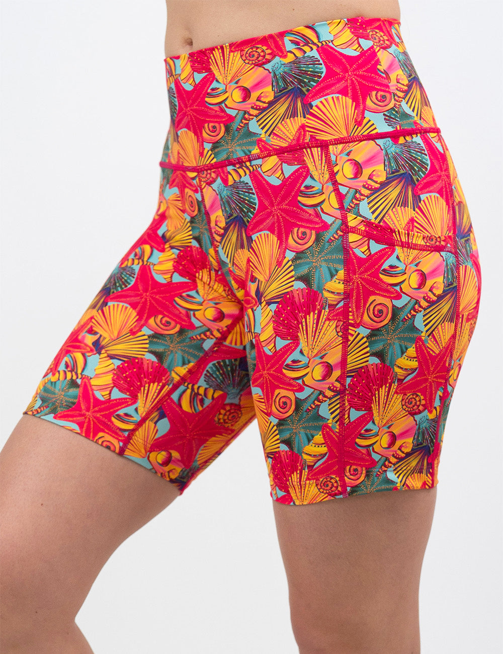 front of the 7 inch front of the red starfish with a yellow and blue shell background shorts against a white background