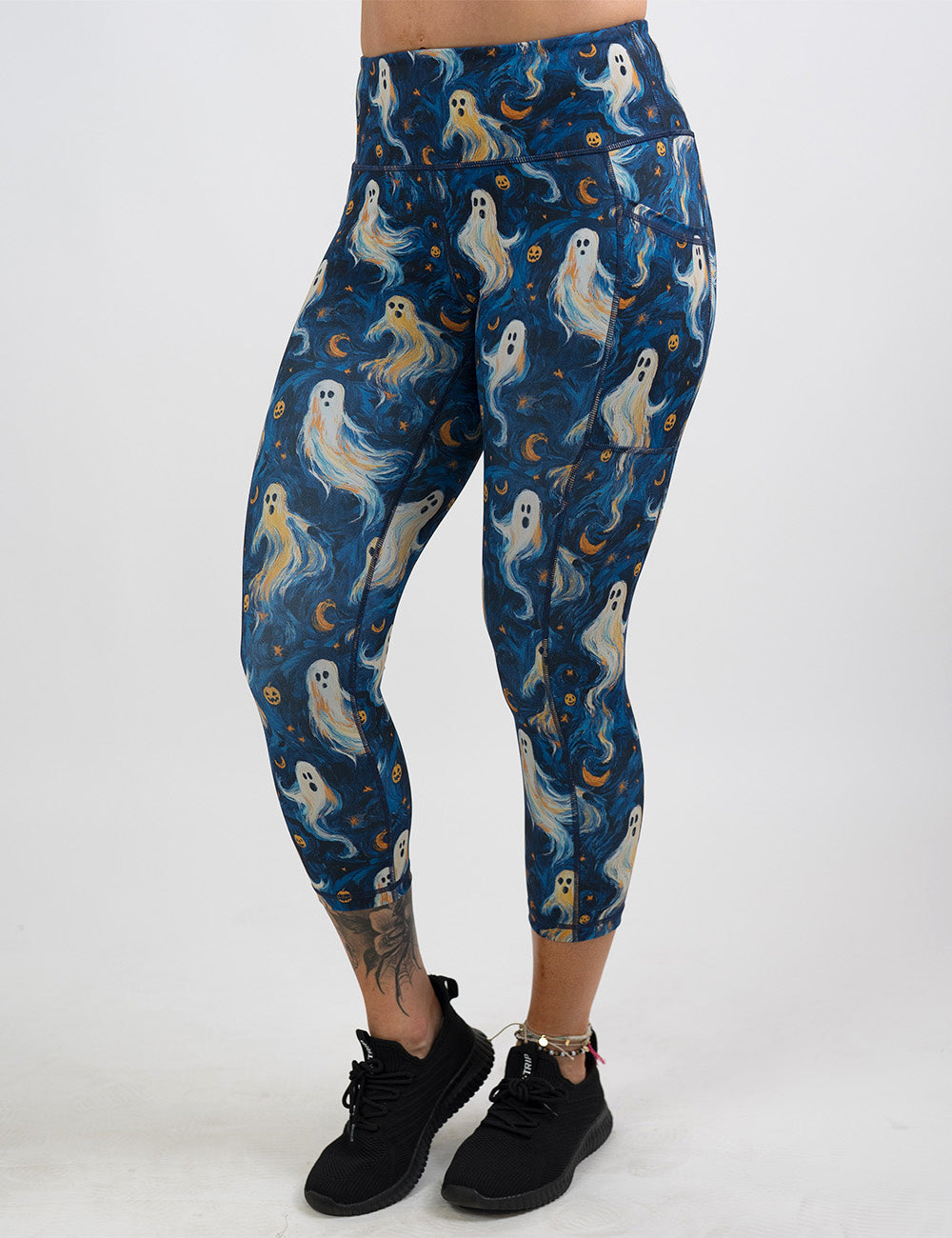front of the starry night ghosts against a blue background pattern capri leggings against a white background