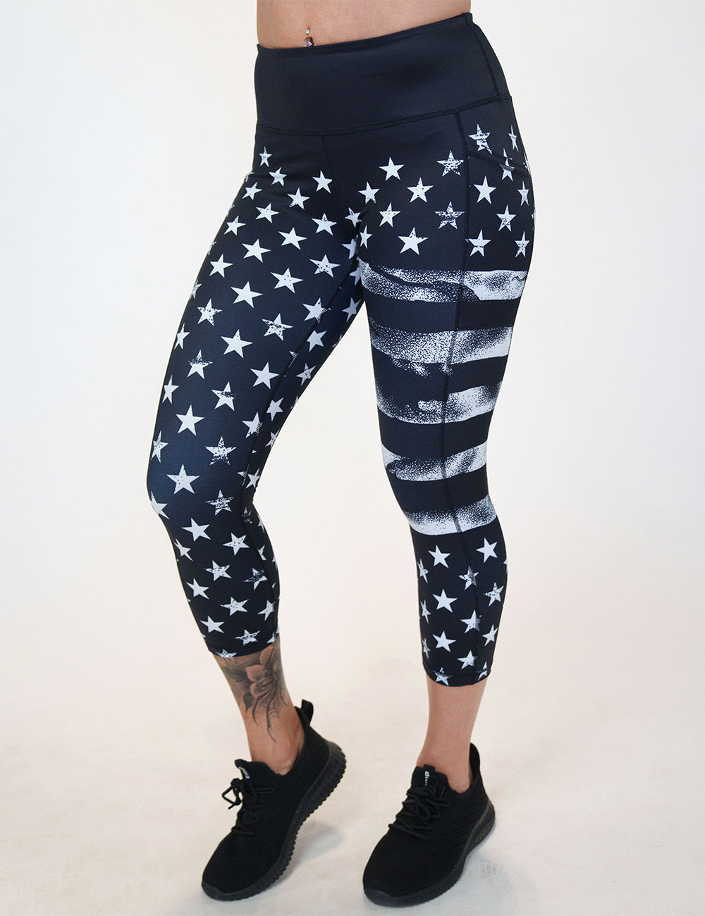 front of the capri black leggings with white American flag design on it against a white background