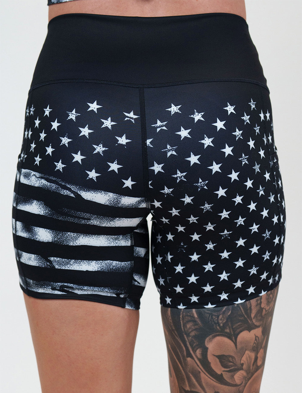 back of the 5 inch black shorts with white stars and stripes against a white background