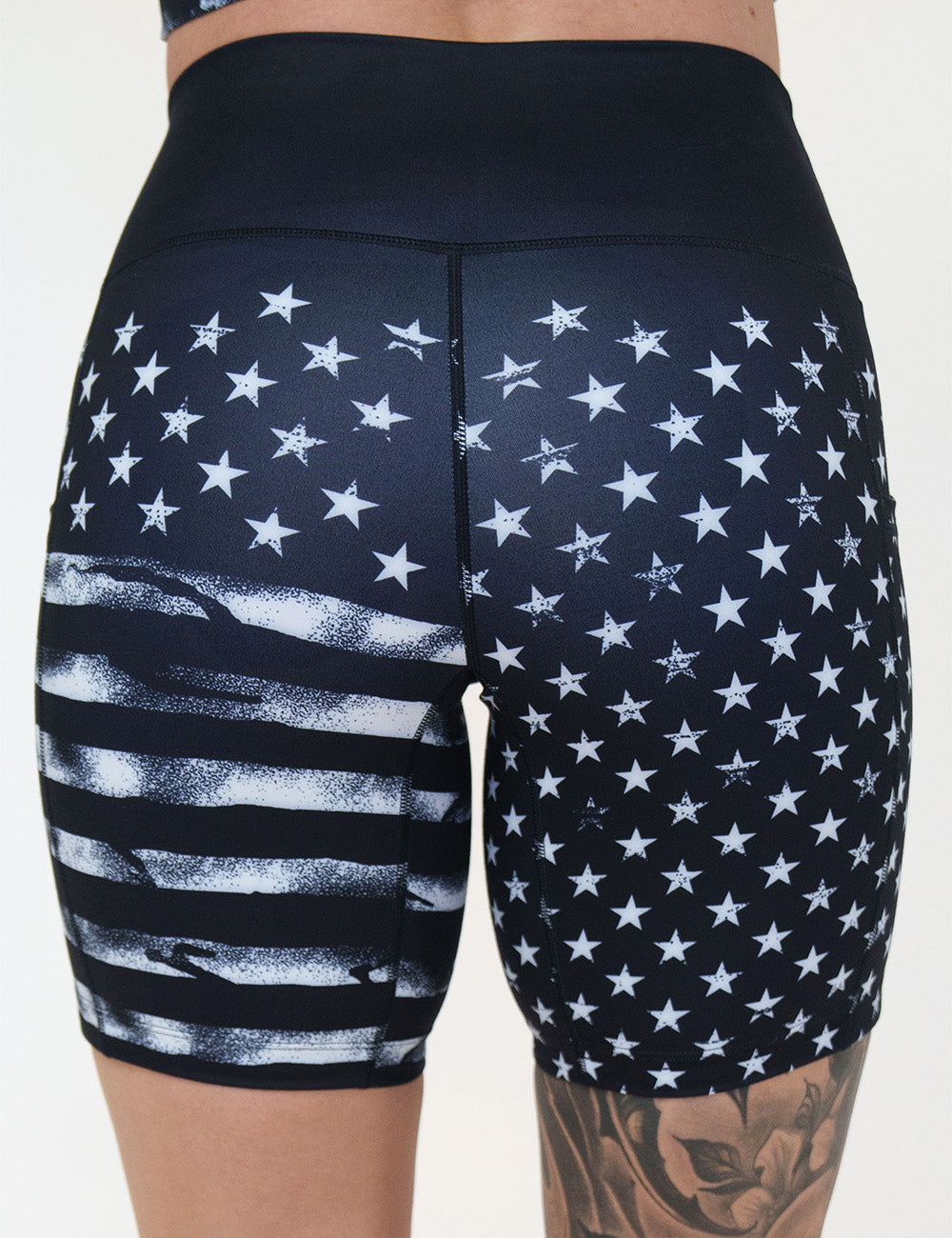 back of the 7 inch black shorts with white stars and stripes against a white background