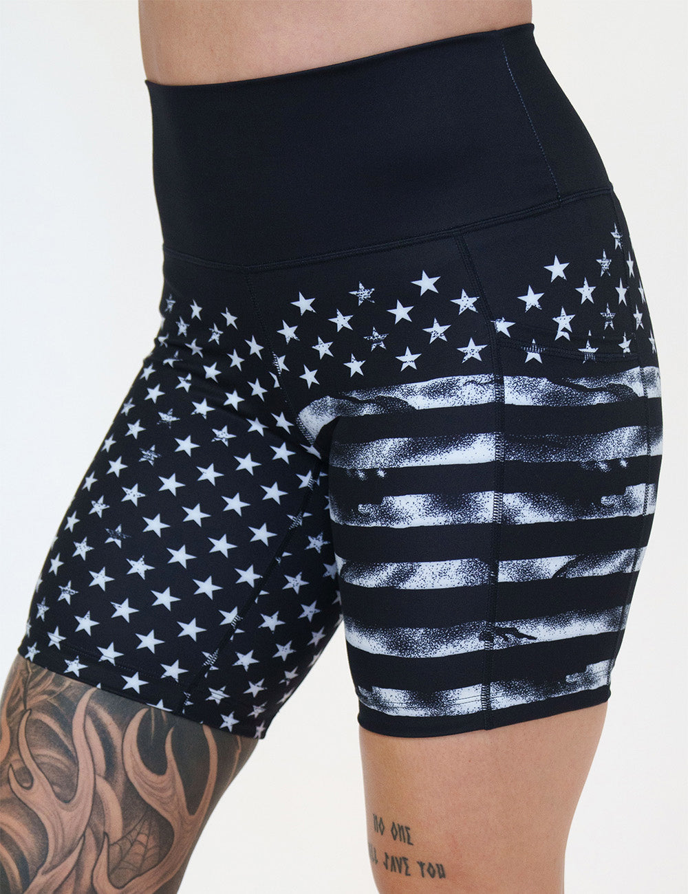 front of the 7 inch black shorts with white stars and stripes against a white background