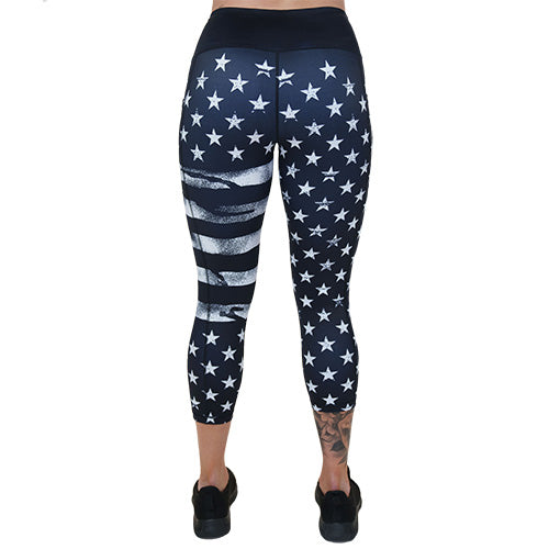 back of the capri length black leggings with white American flag design on it