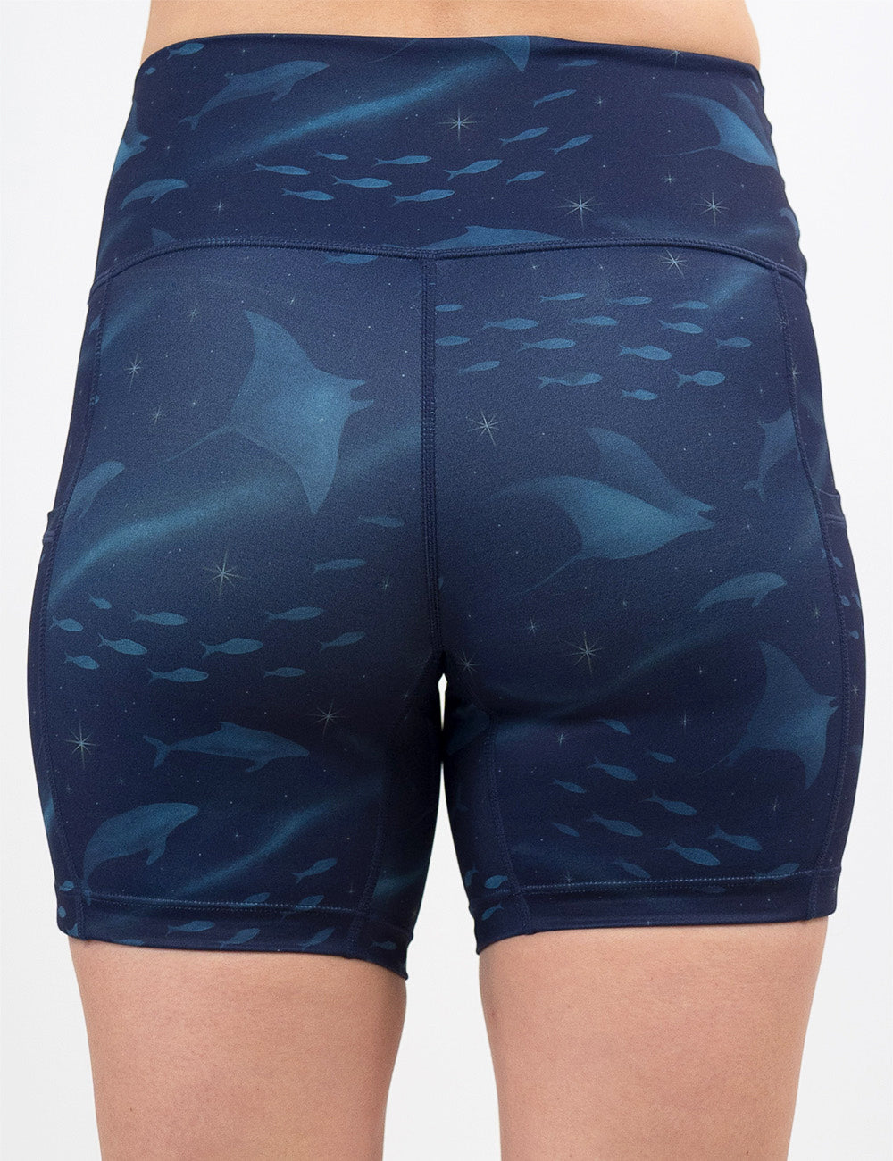 back of the 5 inch dark blue ocean filled with sting rays, whales, and fish shorts against a white background