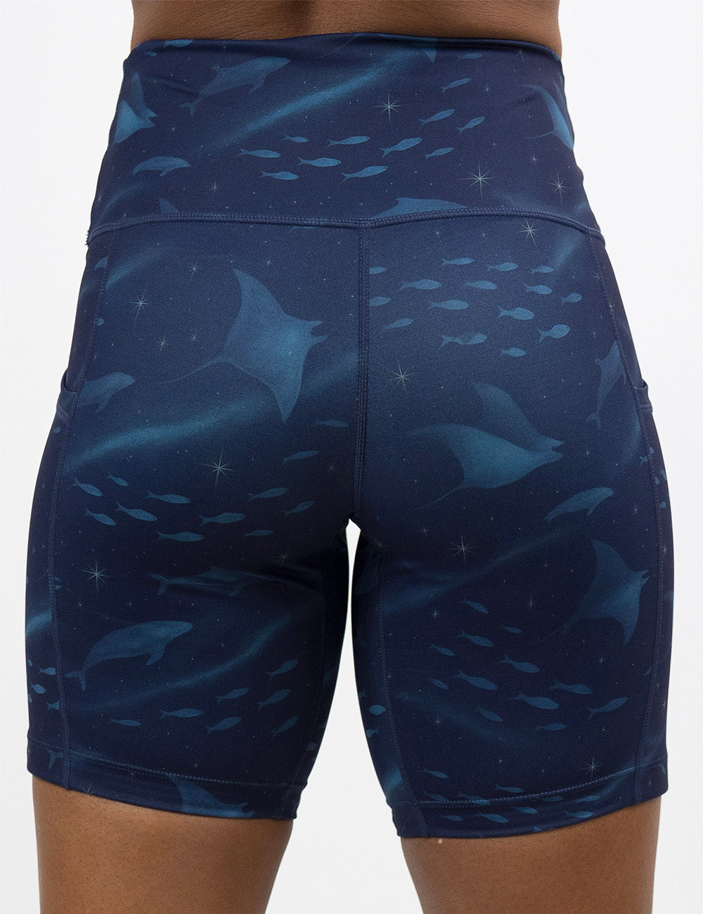 back of the 7 inch dark blue ocean filled with sting rays, whales, and fish shorts against a white background