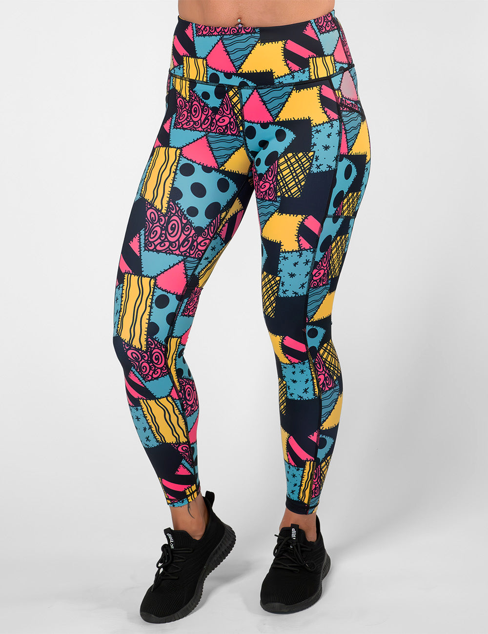 front of the yellow, teal, and pink patchwork design full length leggings against a white background