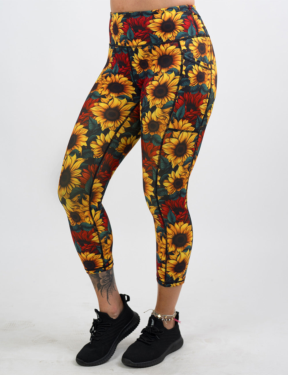 front of the sunflower with red flowers capri leggings against a white background