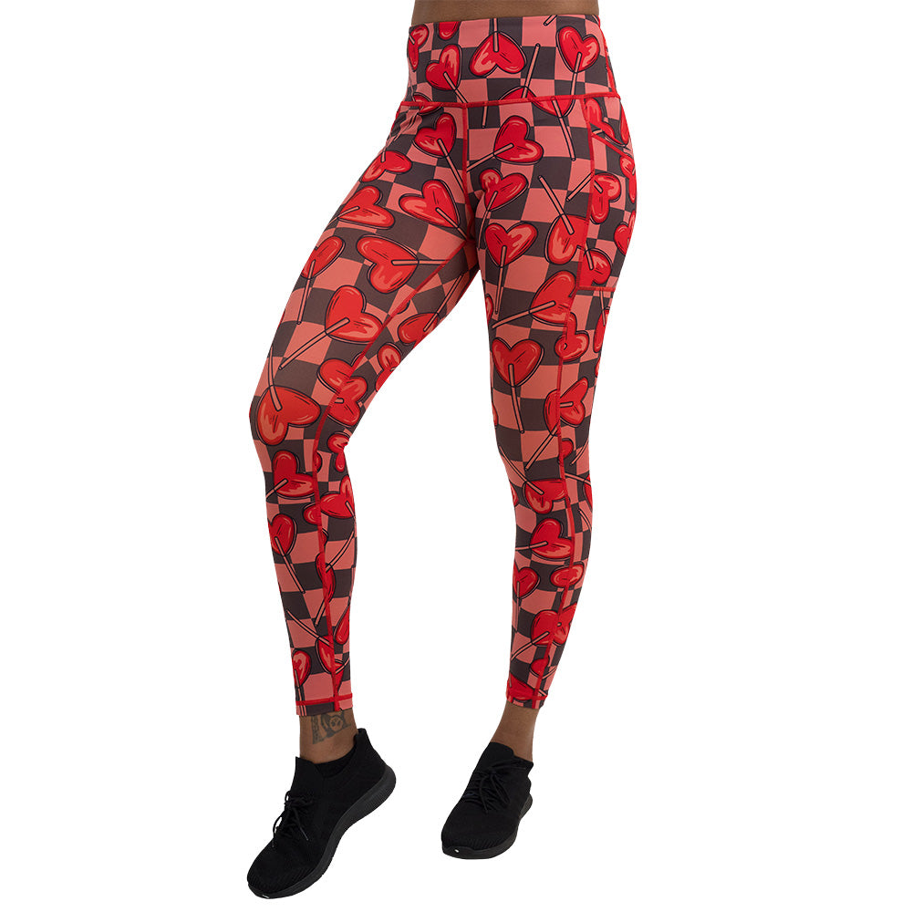 heart lollypops on a checker board background pattern full length leggings facing the front against a white background