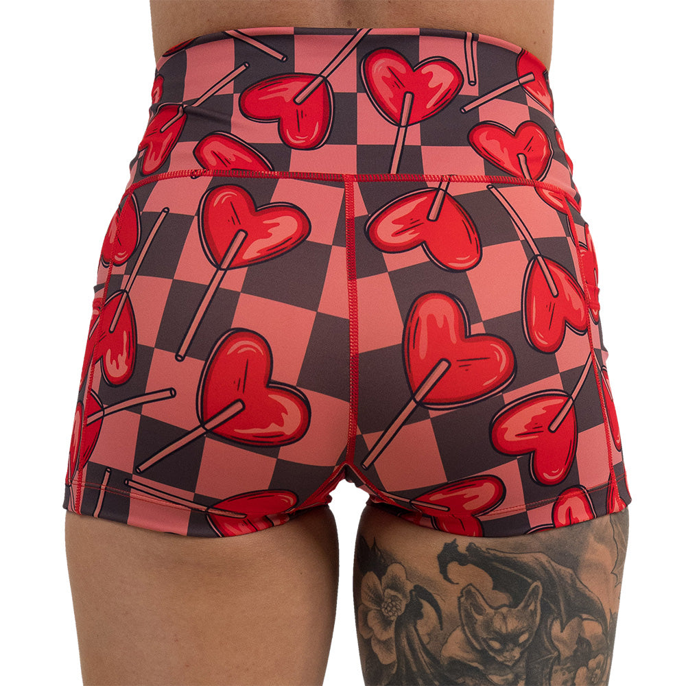 back of the heart lollypops on a checker board pattern 2.5 inch shorts against a white background