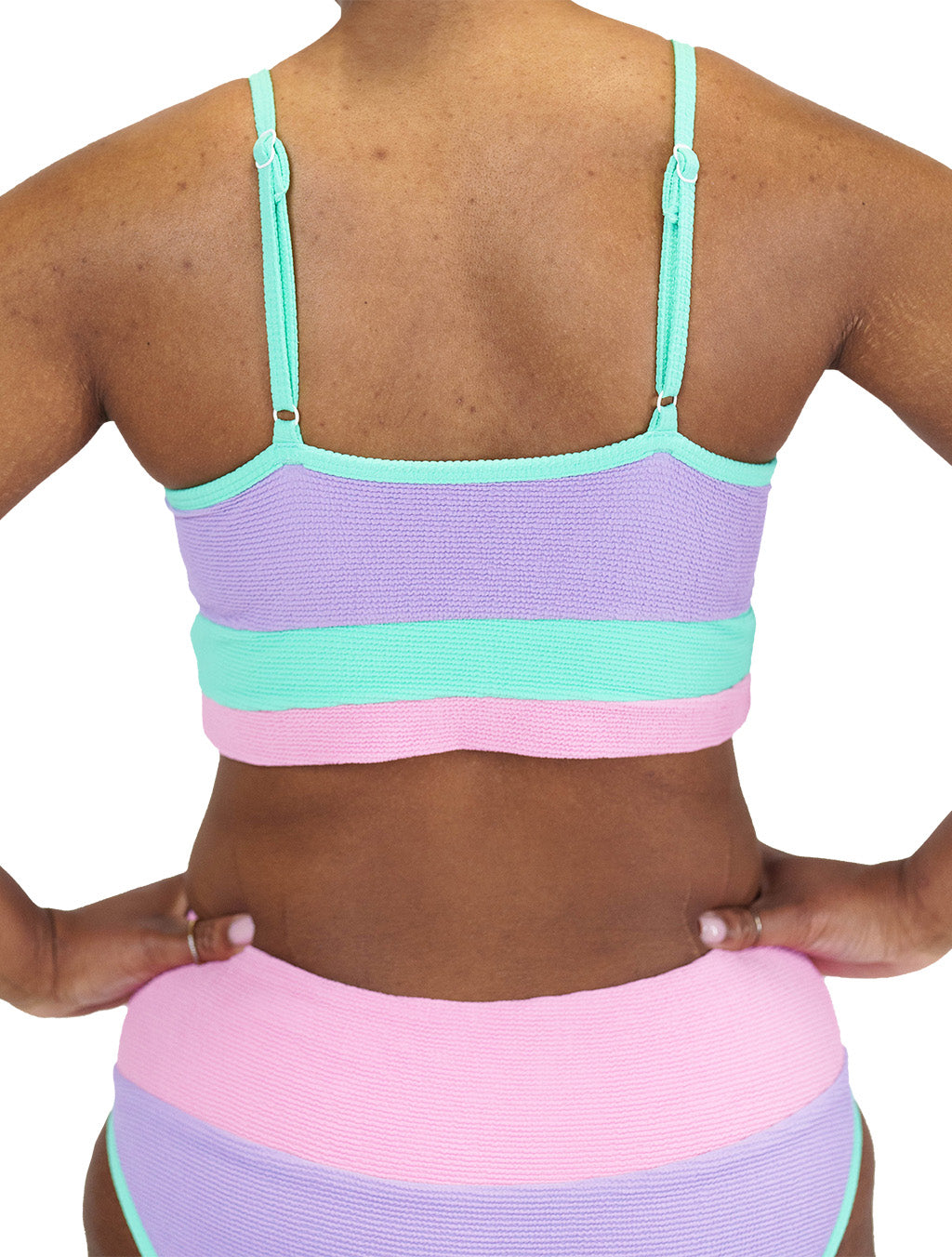 model wearing the pink, purple and teal bathing suit