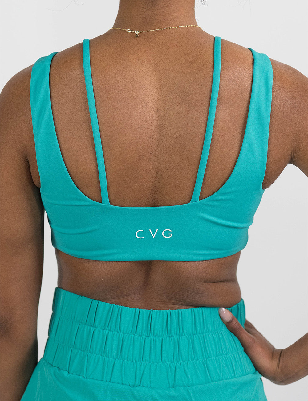 back of the teal vista bra against a white background