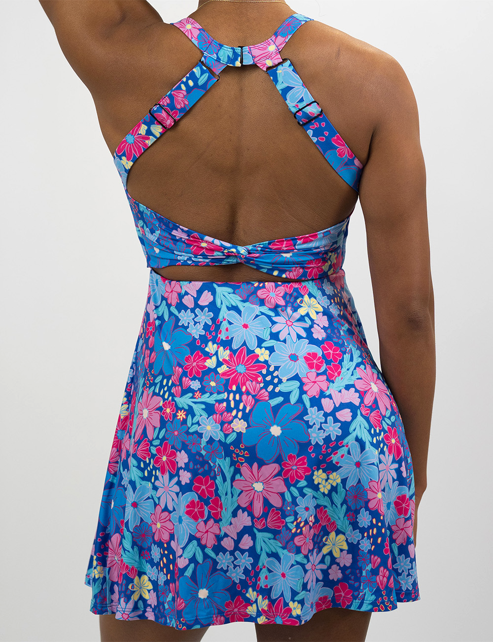 back of the colorful flowers active dress against a white background