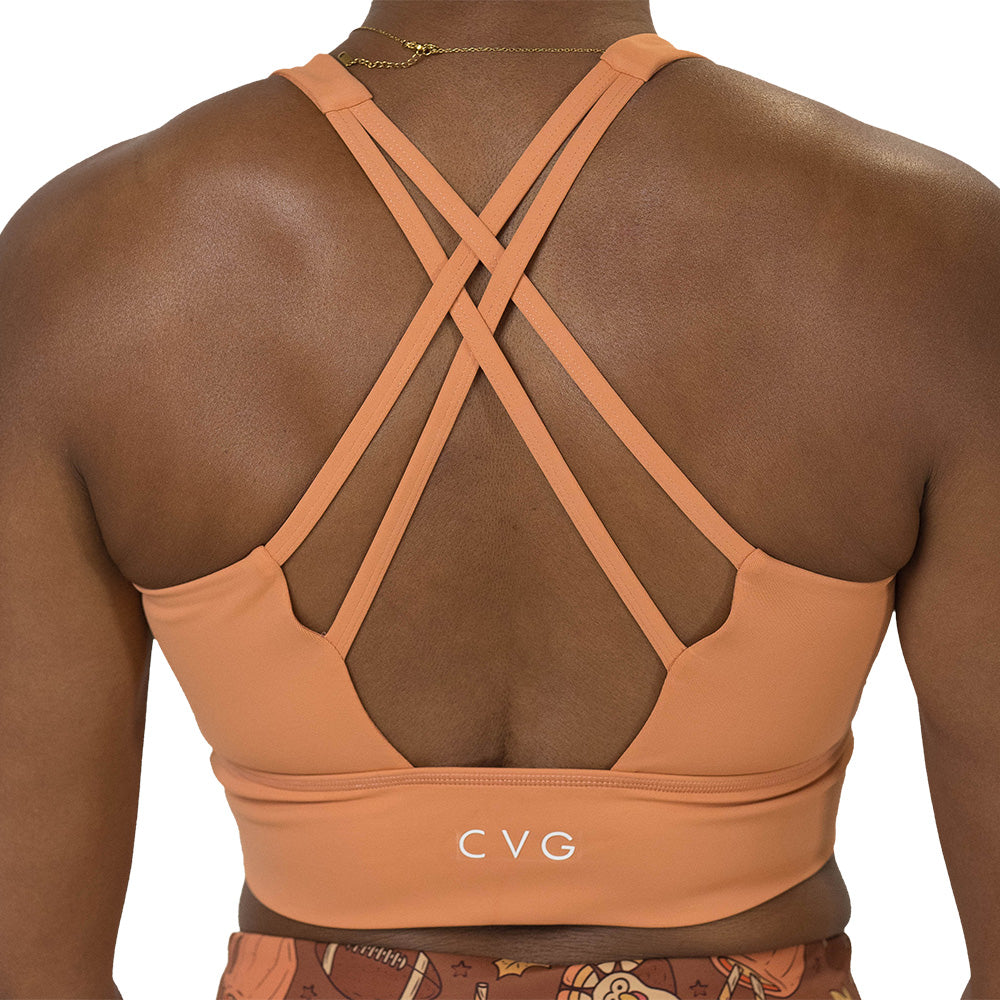 Person wearing a peach-colored sports bra