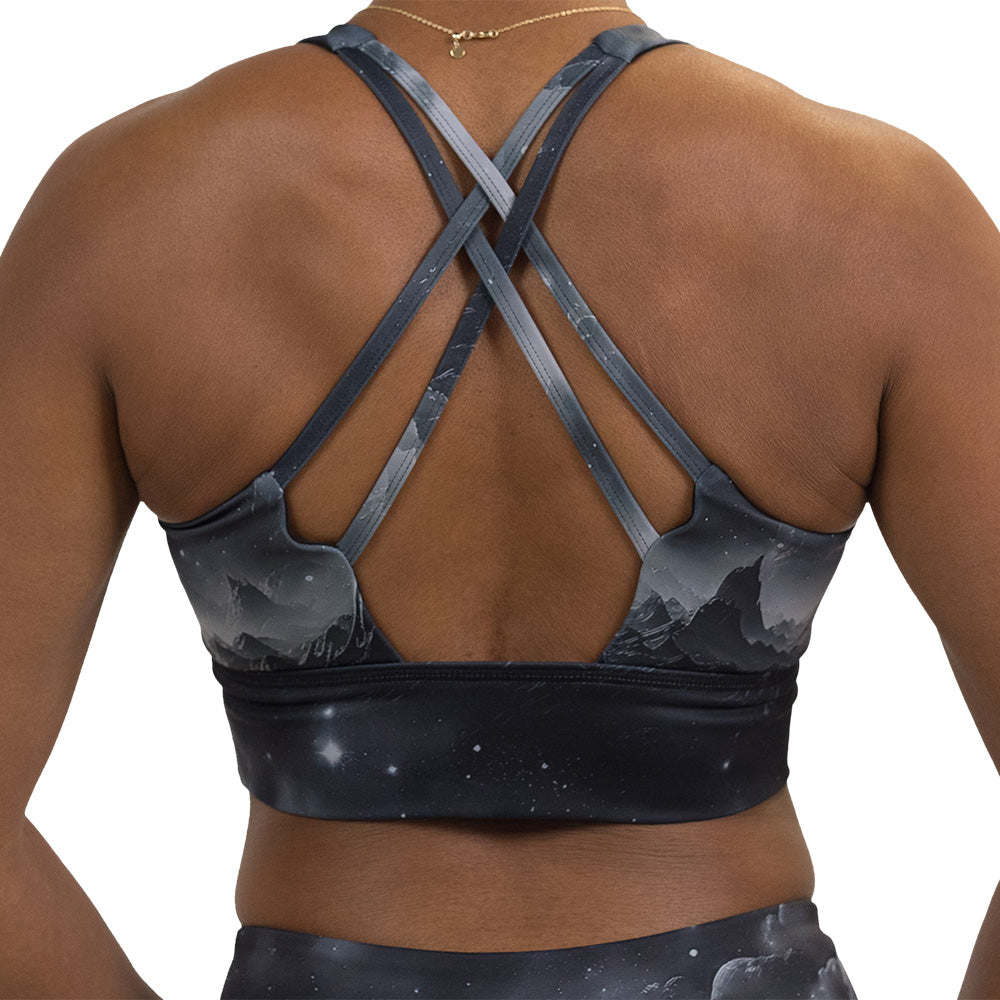 back of the black bra with a mountain and star pattern against a white background