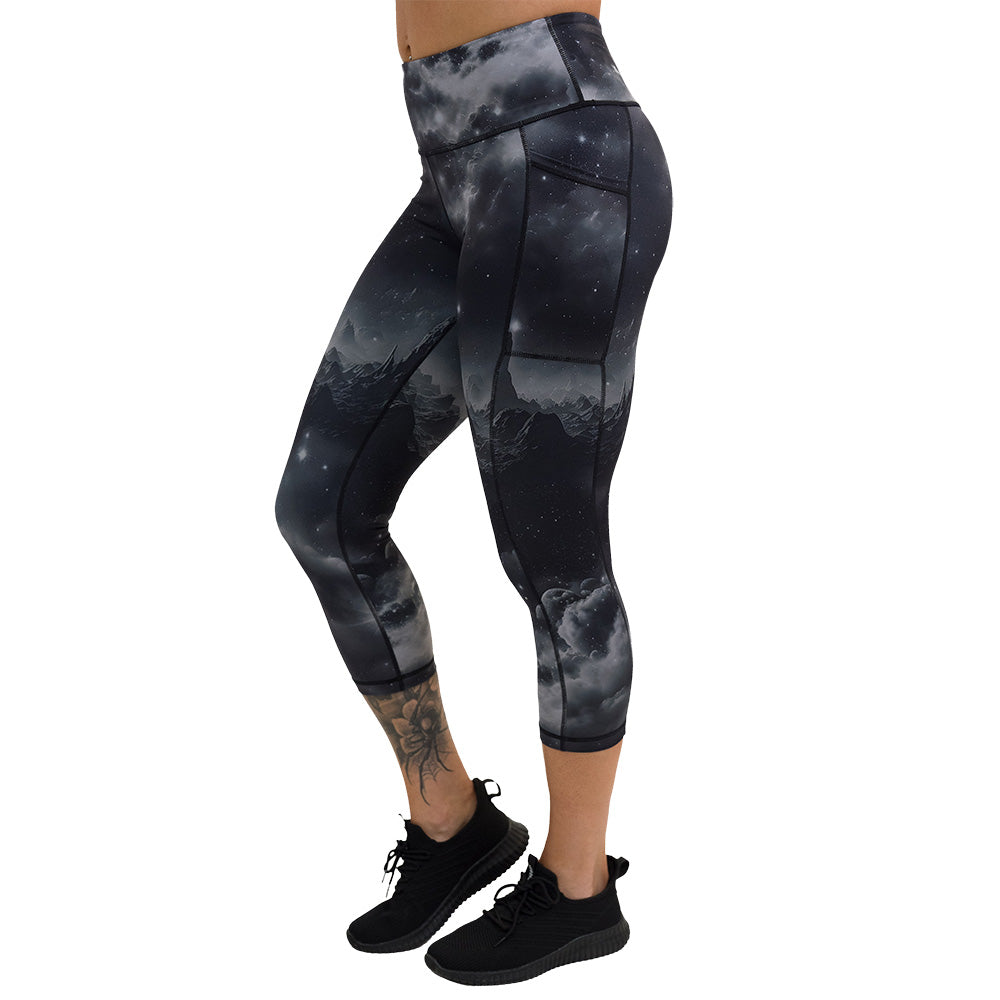 the black capri leggings with mountain and star pattern facing the side against a white background