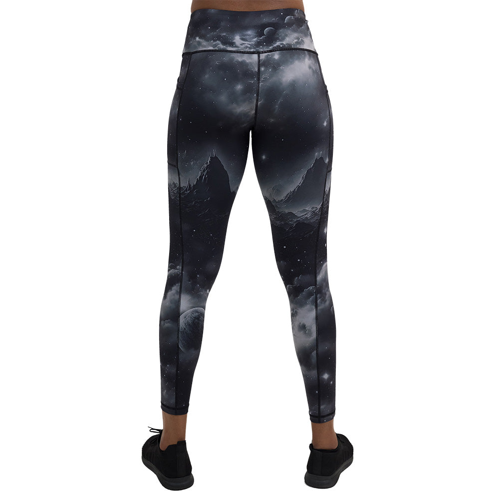 back of the full length black leggings with mountain and star pattern against a white background