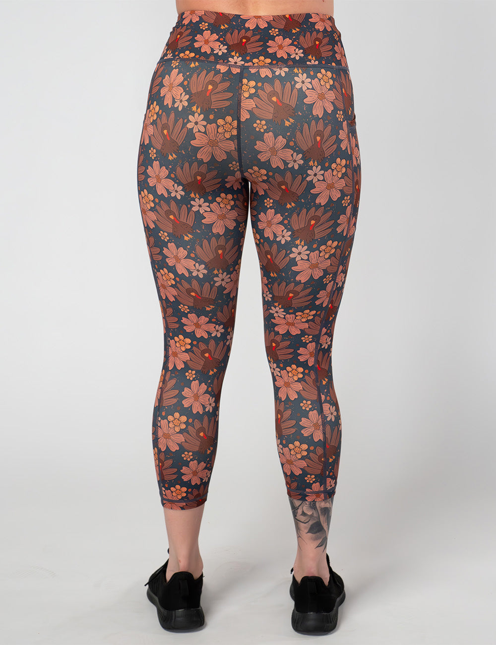 back of the turkeys over a blue background capri leggings against a white background