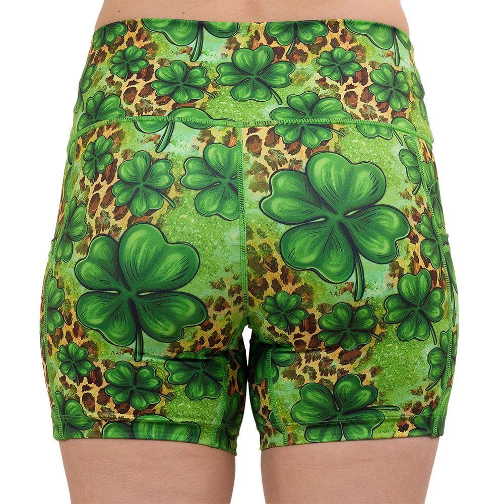 back of the clover pattern against a cheetah print and green background 5 inch shorts against a white background