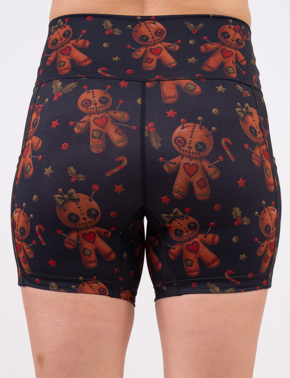 back of the gingerbread voodoo dolls with pins in them surrounded by berries and stars on a black background 5 inch shorts