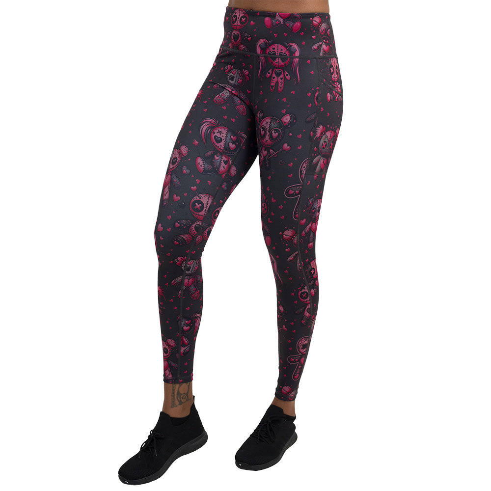 pink voodoo doll with pink hearts pattern full length leggings facing the front against a white background