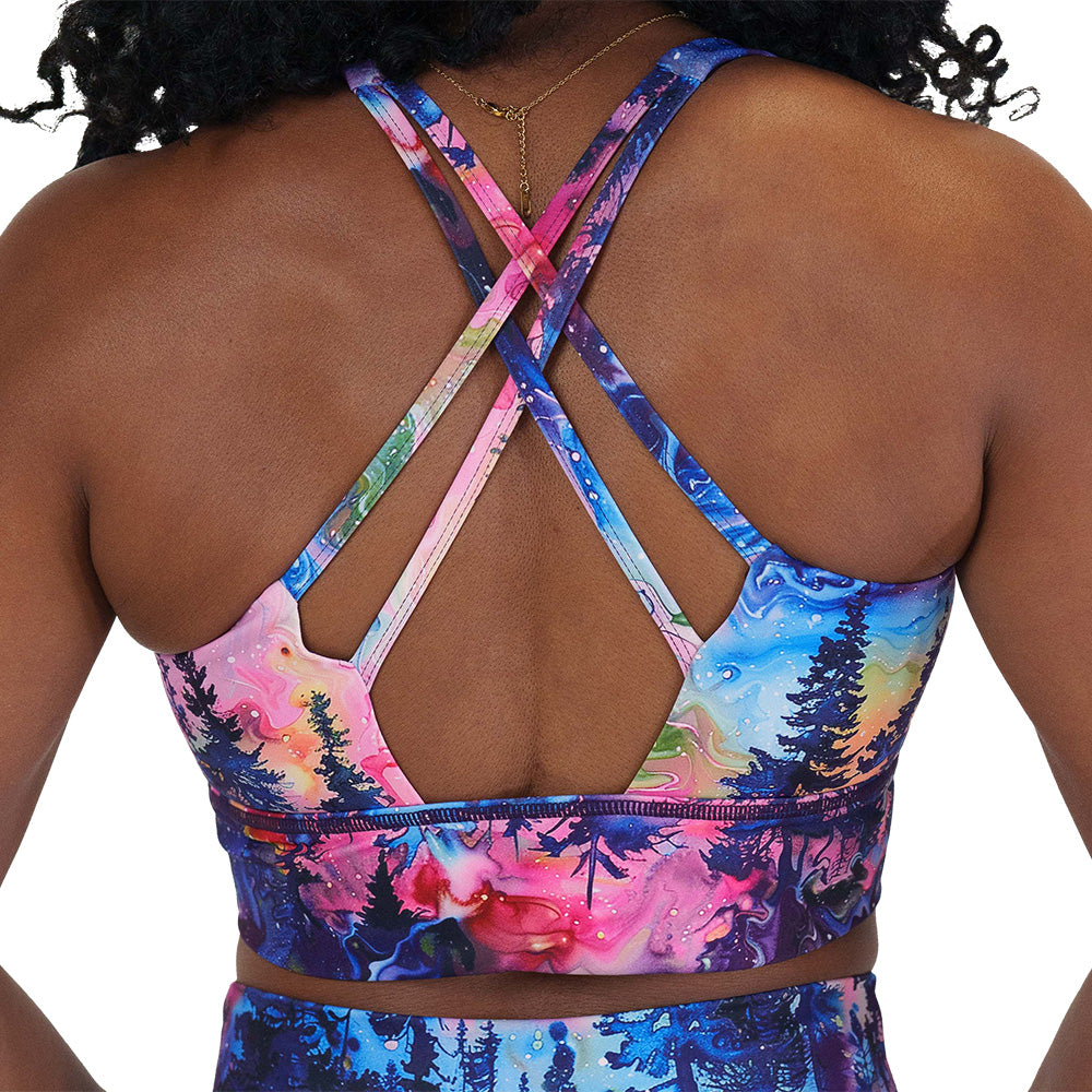 back of the watercolor rainbow patterned forest longline bra against a white background