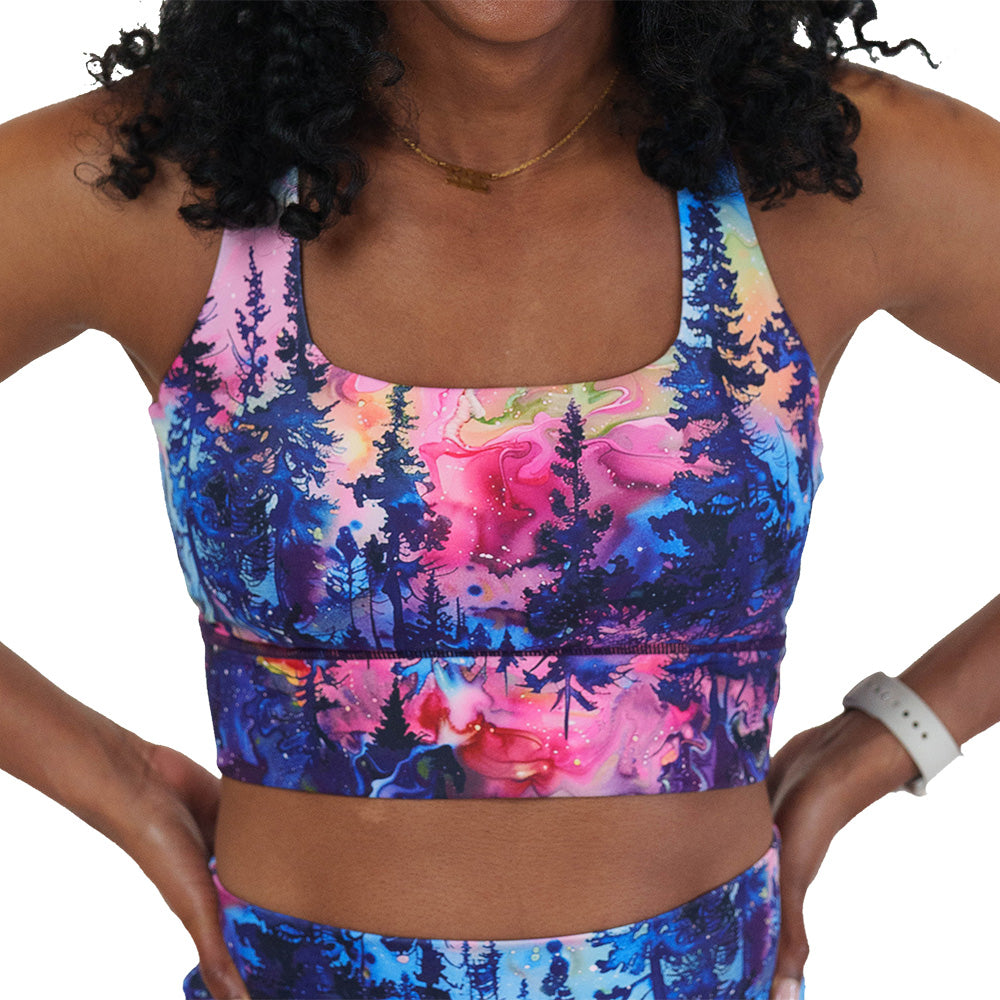 front of the watercolor rainbow patterned forest longline bra against a white background