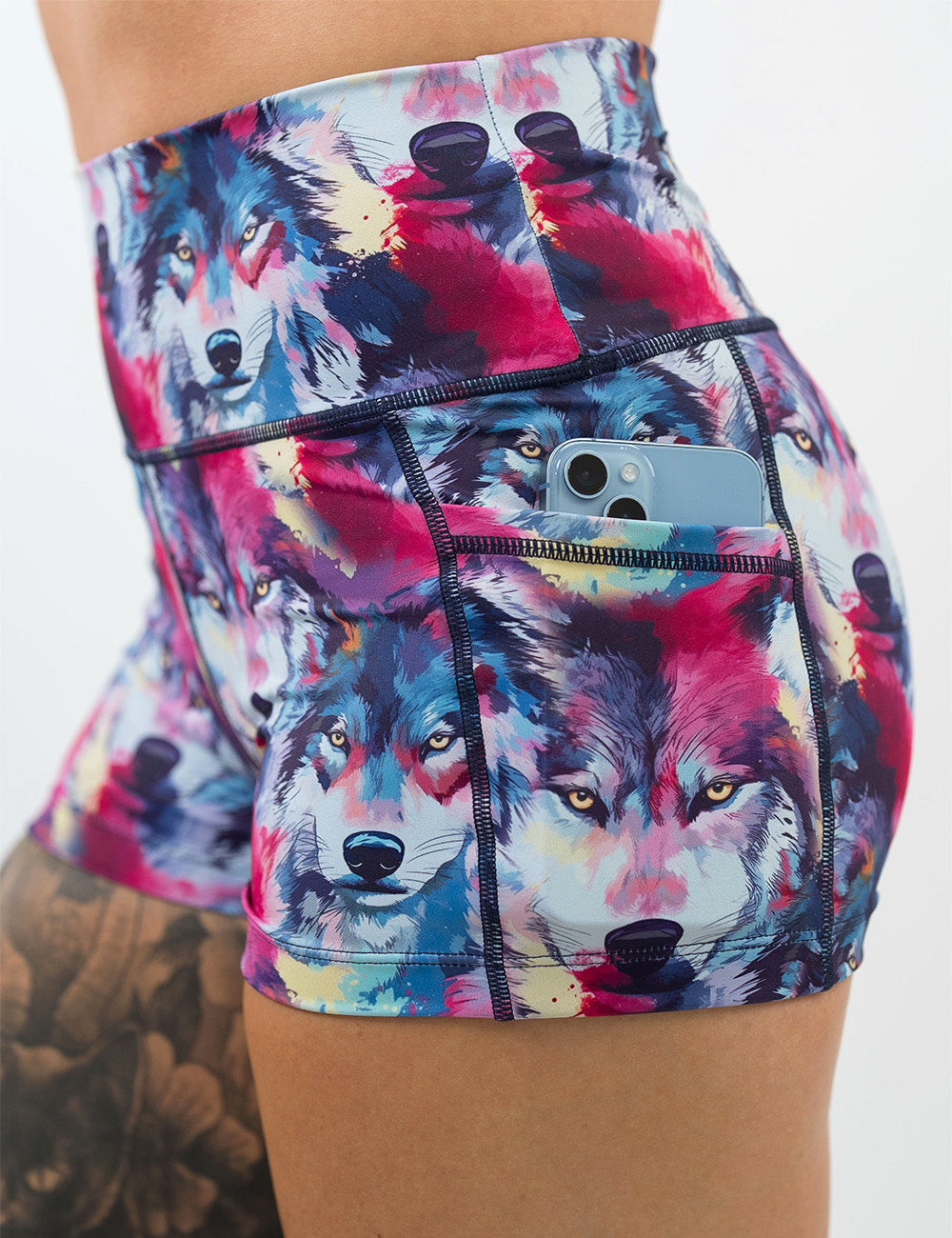 close up of the 2.5 inch red, white, blue, and yellow wolves shorts with a phone in its pocket