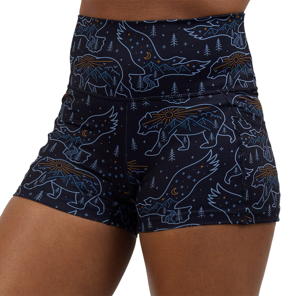 close up of the bird and bear outlines against a dark background 2.5 inch shorts against a white background