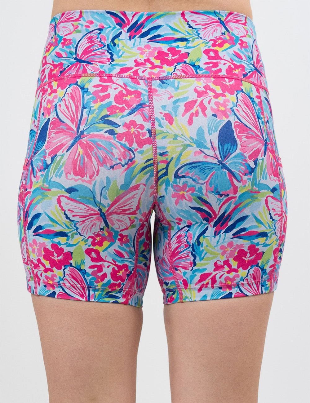 back of the 5 inch pink butterflies against a colorful floral background shorts against a white background