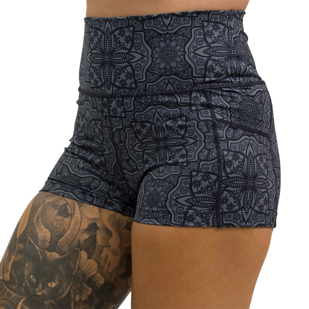close up of black mandala pattern 2.5 inch shorts against a white background