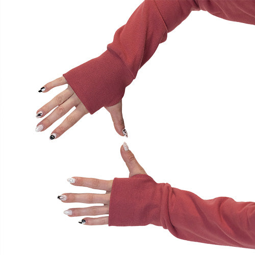 thumbholes on the dark pink zip up sweatshirt