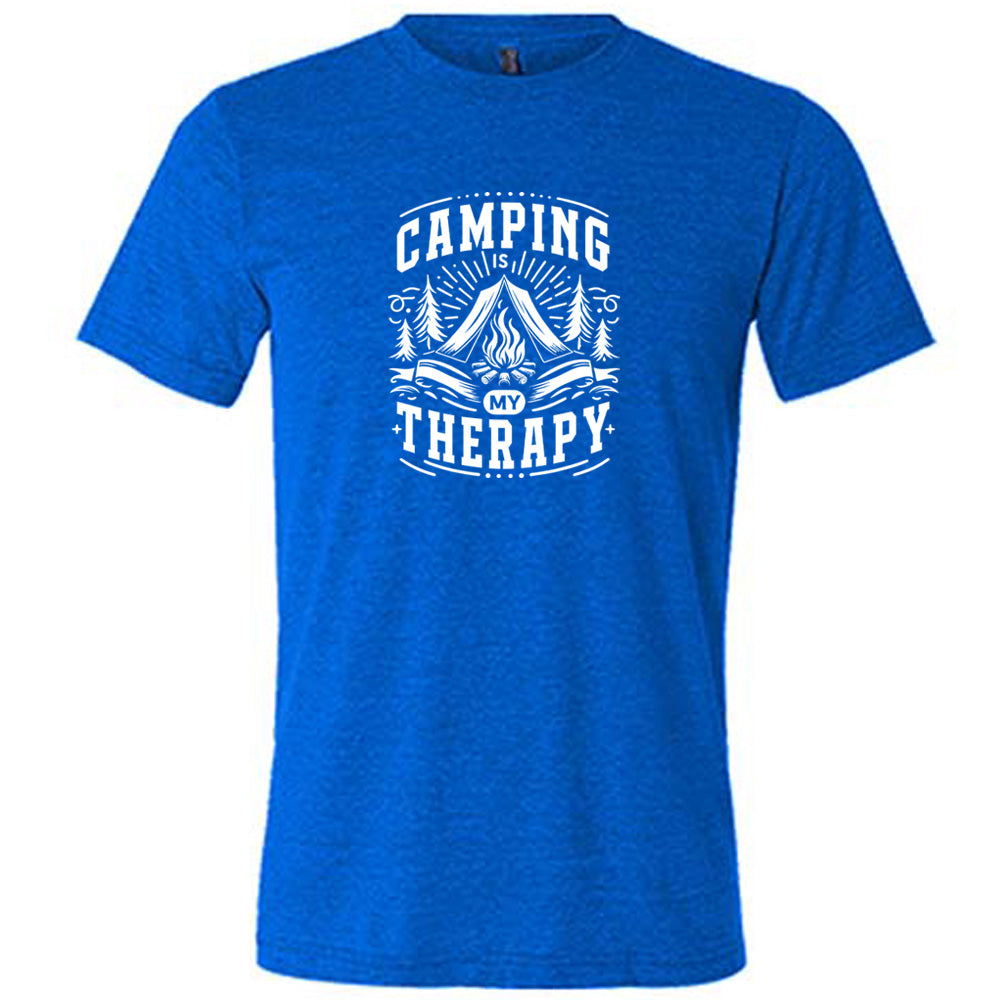 Blue colored shirt with a campfire graphic on it that says "Camping Is My Therapy"