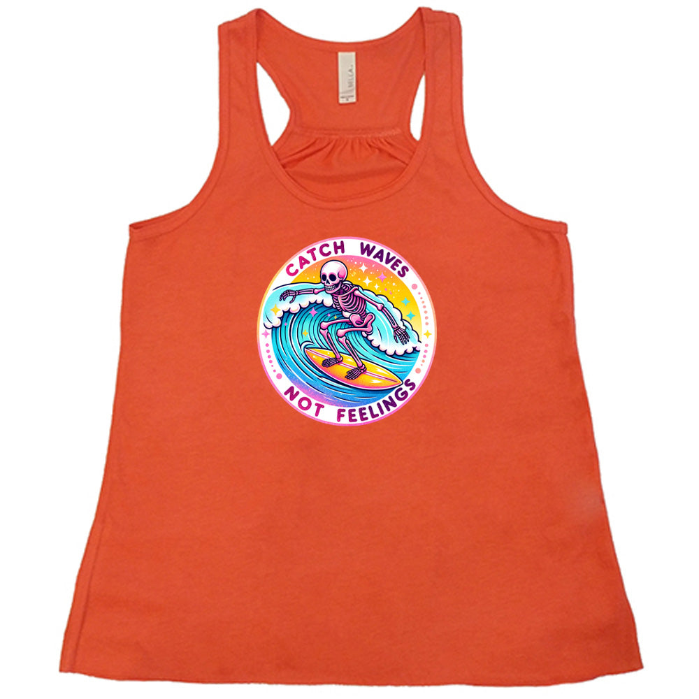 Coral colored flowy tank with a skeleton surfing graphic on it that says "Catch Waves Not Feelings"