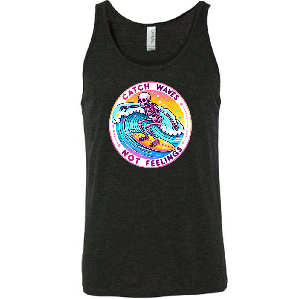 Black colored tank with a skeleton surfing graphic on it that says "Catch Waves Not Feelings"