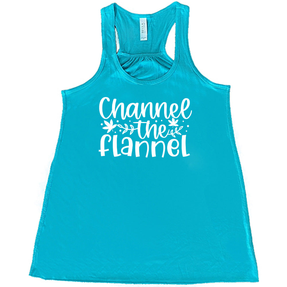 Teal colored flowy tank with fall leaf graphic on it that says "Channel The Flannel"