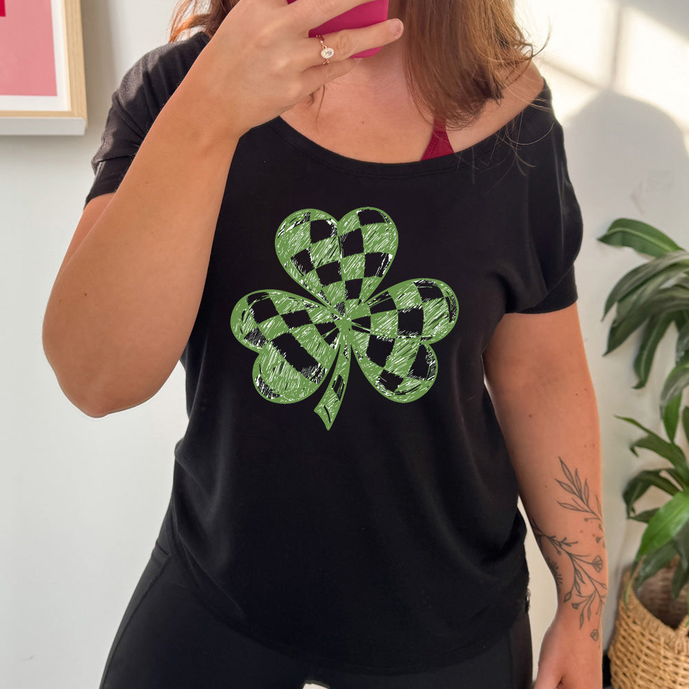 black slouchy tee with the large graphic of a shamrock that is checkered on the inside