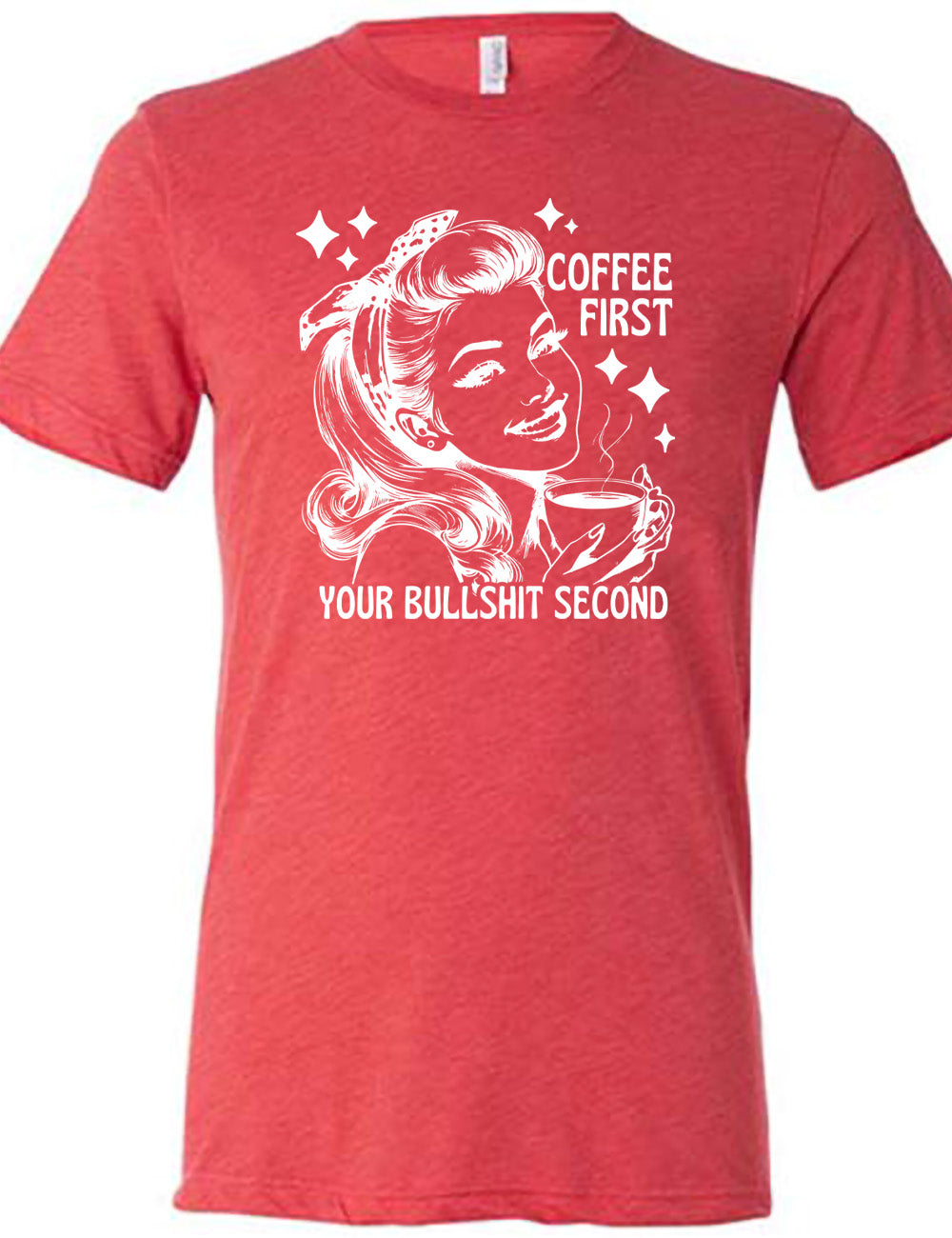 red unisex tee with the graphic of a woman happily holding a mug of steaming coffee, with the words "coffee first" (next to her face) and "your bullshit second" underneath, and a few stars around her